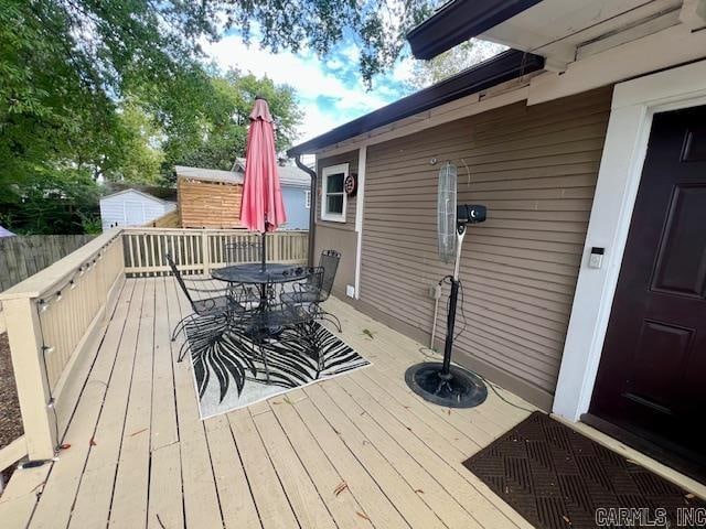 wooden deck with outdoor dining area