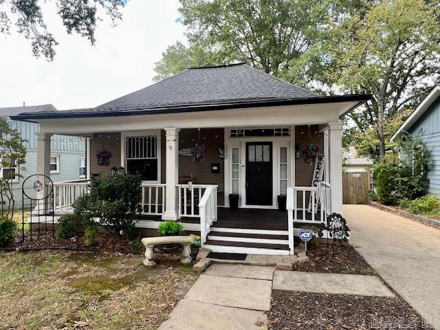 bungalow featuring covered porch and roof with shingles