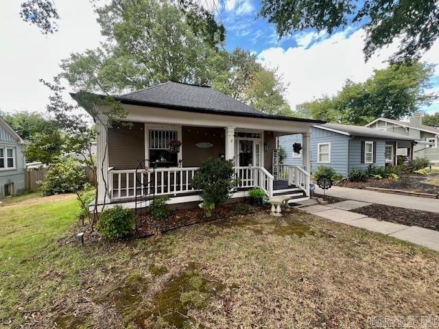 bungalow-style house featuring a porch and a front yard