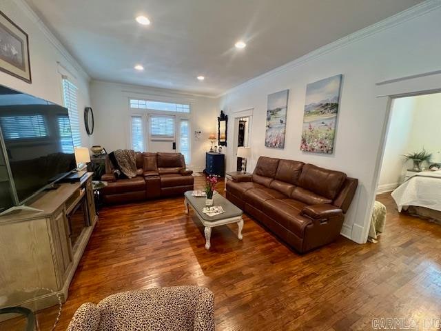 living area with ornamental molding, dark wood-style flooring, and recessed lighting