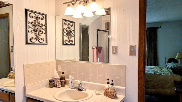 bathroom with tasteful backsplash and vanity