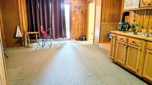 carpeted living room with ceiling fan with notable chandelier and a healthy amount of sunlight