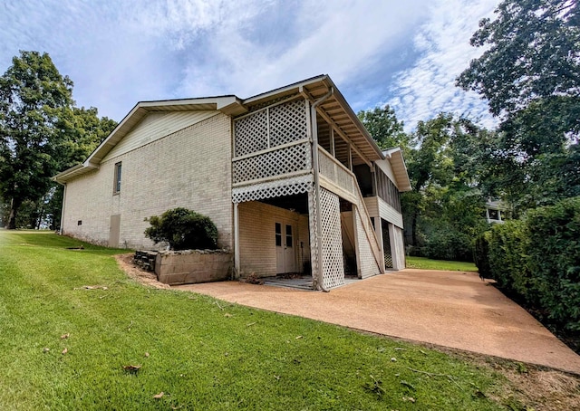 view of property exterior featuring a lawn and a patio