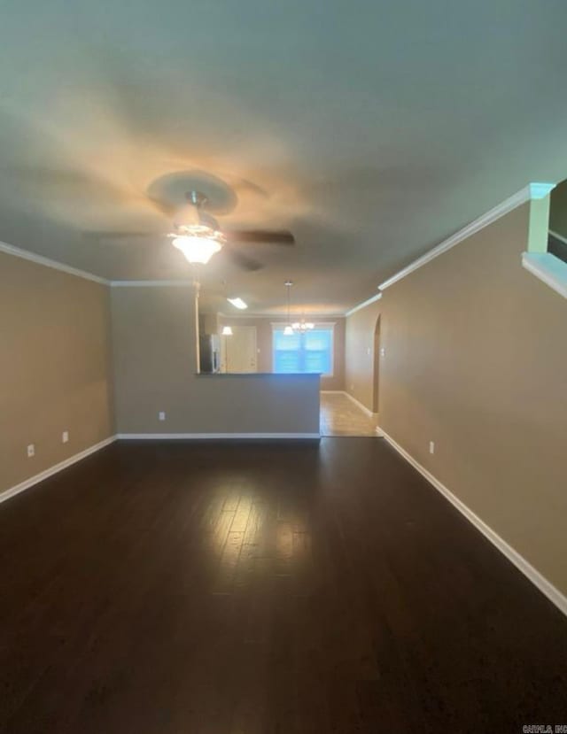 spare room with crown molding, dark hardwood / wood-style flooring, and ceiling fan