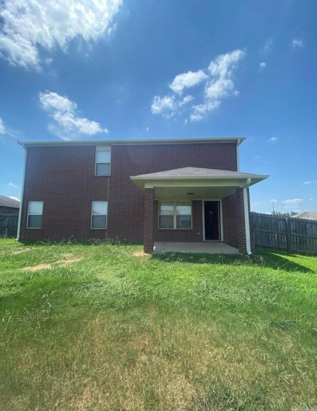 view of front of house featuring a front yard and a patio