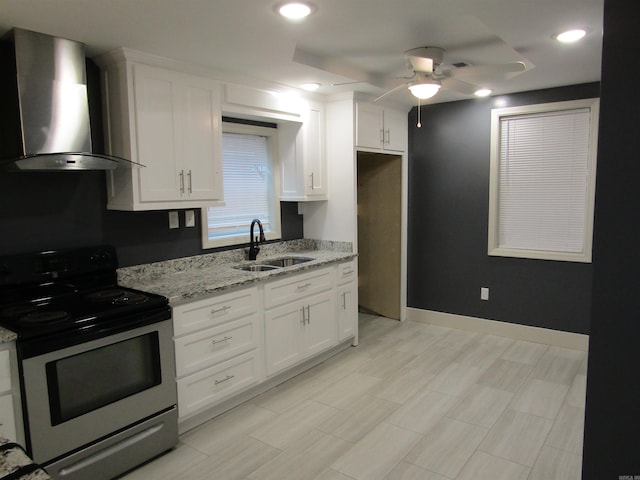 kitchen featuring electric stove, white cabinets, wall chimney exhaust hood, and sink