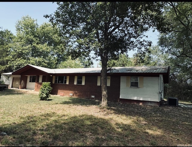 ranch-style home with metal roof, an attached garage, brick siding, crawl space, and a front yard