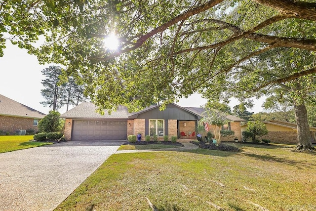 view of front of property featuring brick siding, concrete driveway, a front yard, central AC, and a garage