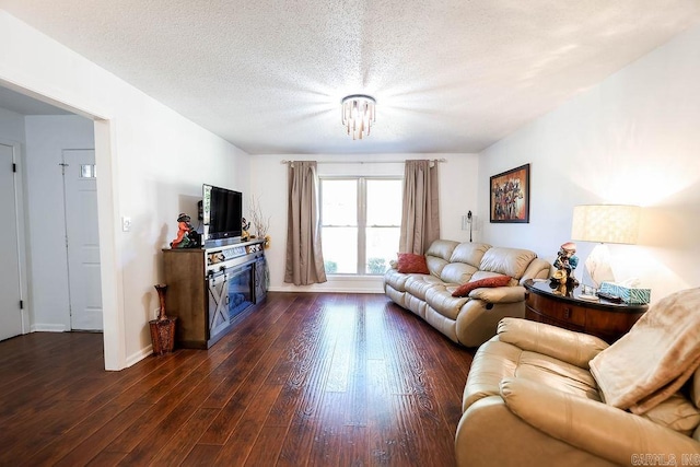 living room featuring a textured ceiling and dark wood-type flooring