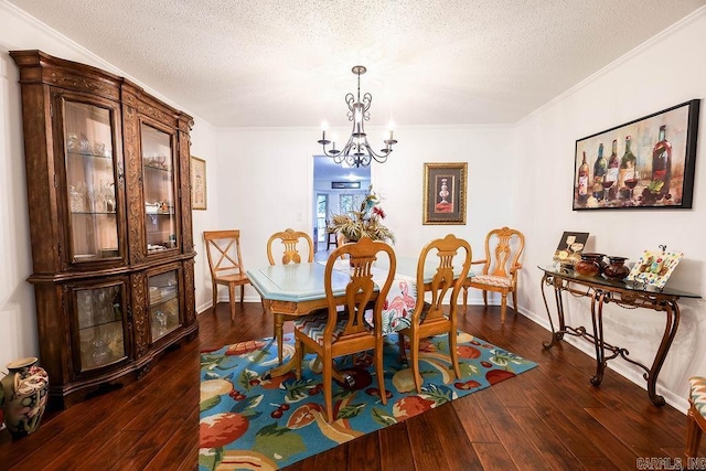 dining room with dark hardwood / wood-style floors, a chandelier, ornamental molding, and a textured ceiling