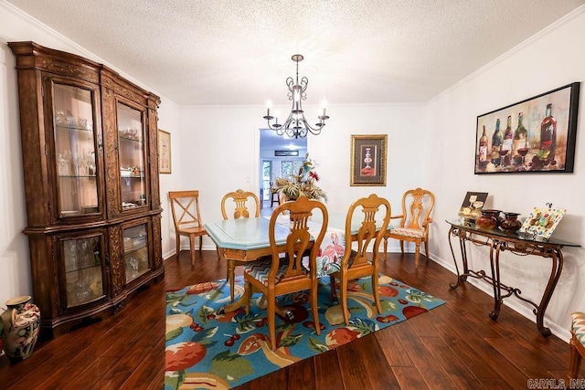 dining room with a chandelier, a textured ceiling, baseboards, dark wood-style floors, and crown molding