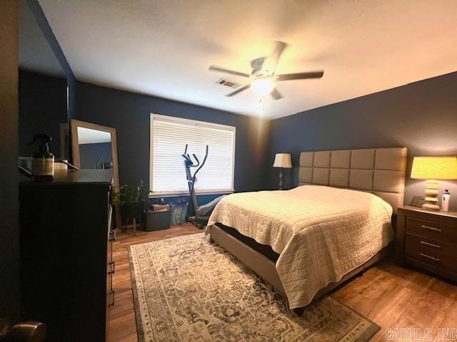 bedroom featuring ceiling fan and hardwood / wood-style flooring