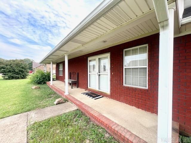 doorway to property featuring a yard