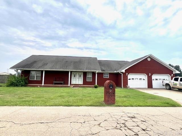 ranch-style house with a garage and a front yard