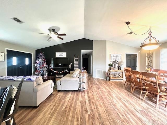 living room featuring vaulted ceiling, hardwood / wood-style floors, and ceiling fan