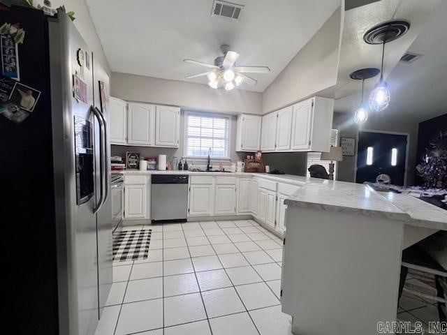 kitchen with hanging light fixtures, stainless steel appliances, white cabinetry, kitchen peninsula, and ceiling fan