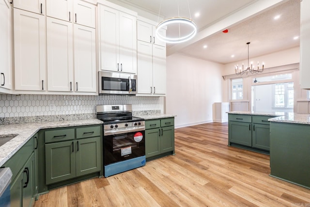 kitchen featuring light wood-type flooring, green cabinets, stainless steel appliances, and white cabinets