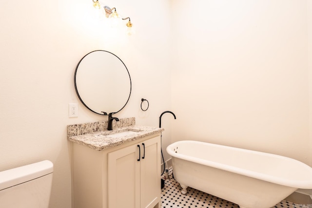 bathroom with a tub to relax in, vanity, toilet, and tile patterned floors