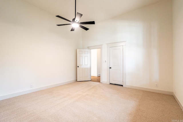 interior space with a high ceiling and ceiling fan