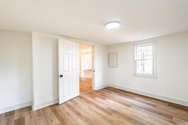 spare room with light hardwood / wood-style floors