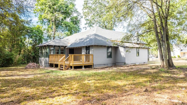 back of house with a sunroom, a yard, and a wooden deck