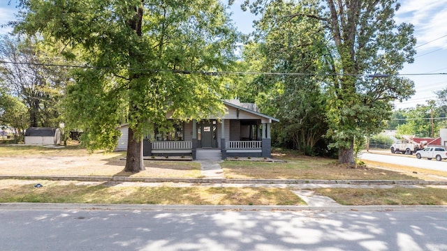 view of front facade with a storage unit and a porch