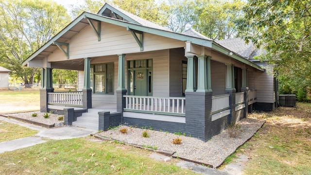 view of front of home featuring cooling unit and a porch