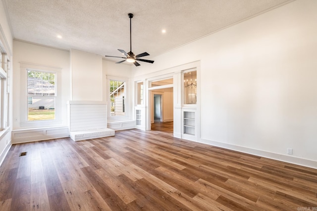 unfurnished living room featuring hardwood / wood-style floors, ceiling fan, and a textured ceiling