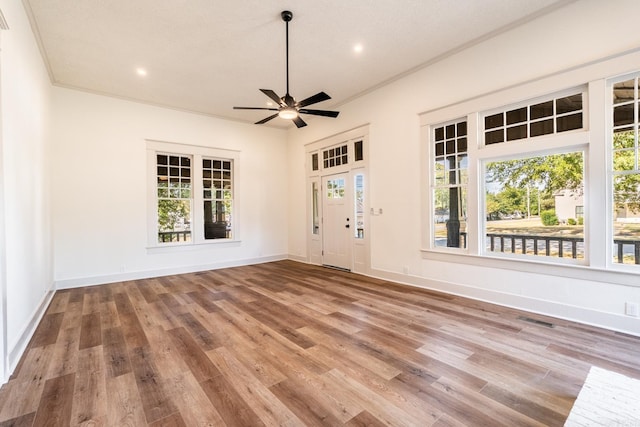 spare room with a textured ceiling, ceiling fan, ornamental molding, and wood-type flooring