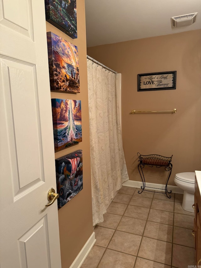 bathroom featuring toilet, a shower with curtain, vanity, and tile patterned flooring