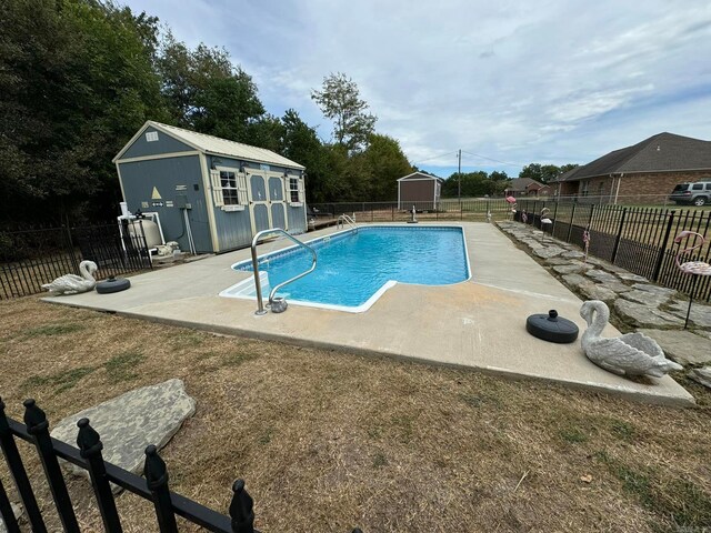 view of pool featuring a patio area and a shed