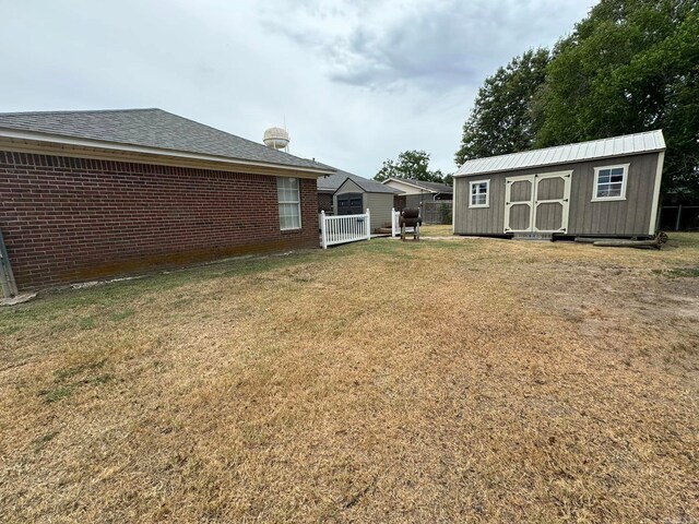 view of yard with a storage unit and an outbuilding