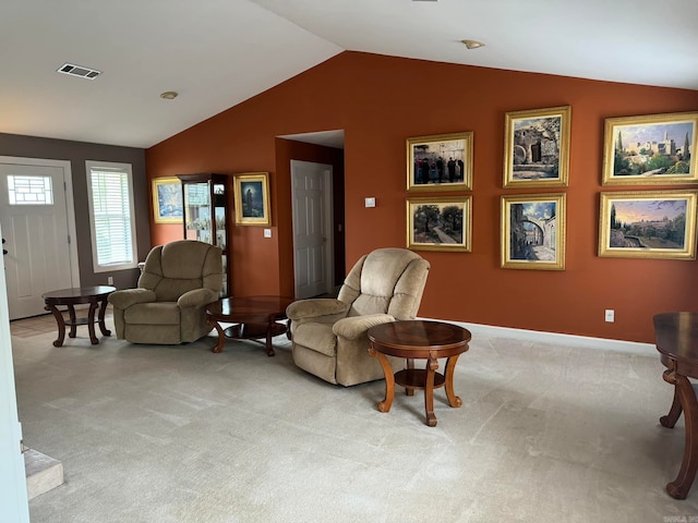 carpeted living room with lofted ceiling