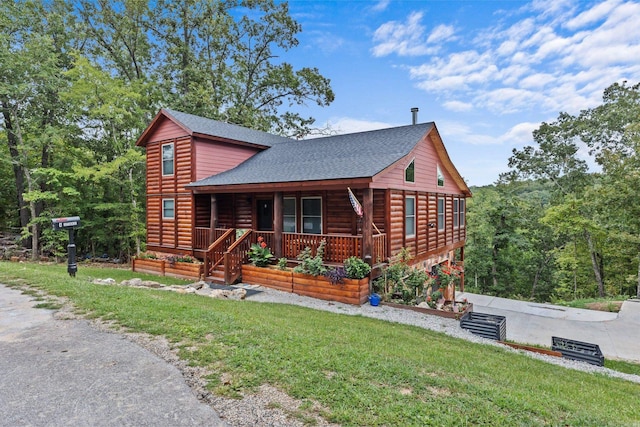 log home with a front yard and covered porch