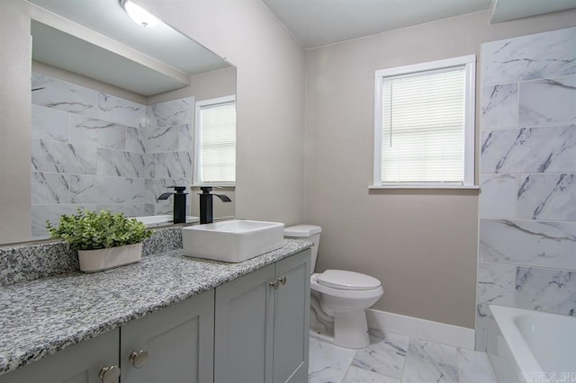 bathroom with vanity, a healthy amount of sunlight, and toilet