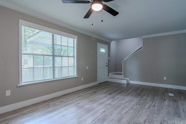 interior space featuring crown molding, a healthy amount of sunlight, ceiling fan, and light hardwood / wood-style floors