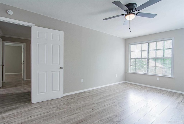 empty room with light wood-type flooring and ceiling fan