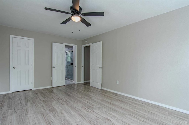 unfurnished bedroom with ceiling fan, light wood-type flooring, and ensuite bathroom