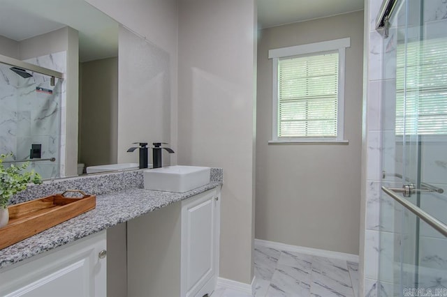 bathroom featuring vanity, toilet, and walk in shower