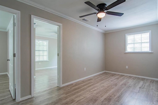 spare room with crown molding, light hardwood / wood-style flooring, and ceiling fan