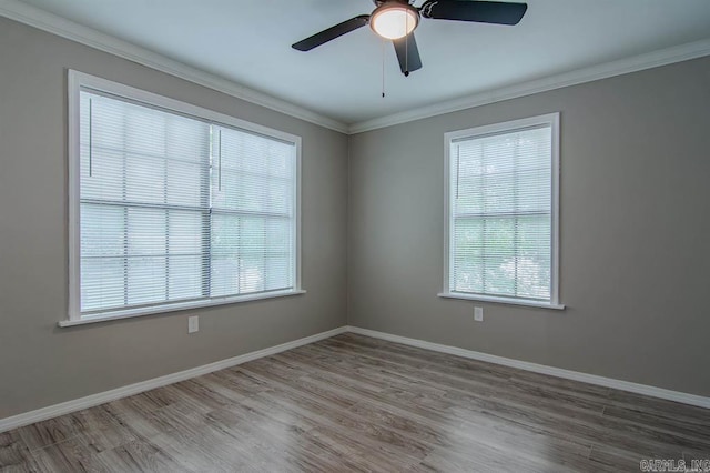 empty room with crown molding, hardwood / wood-style floors, and ceiling fan