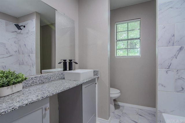 bathroom featuring tiled shower, vanity, and toilet