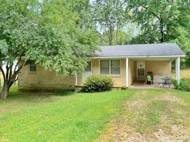 rear view of property featuring a lawn