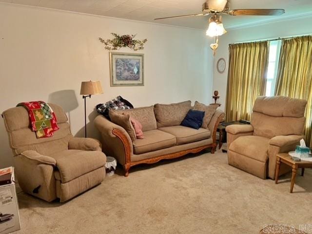 living room featuring ornamental molding, ceiling fan, and carpet floors