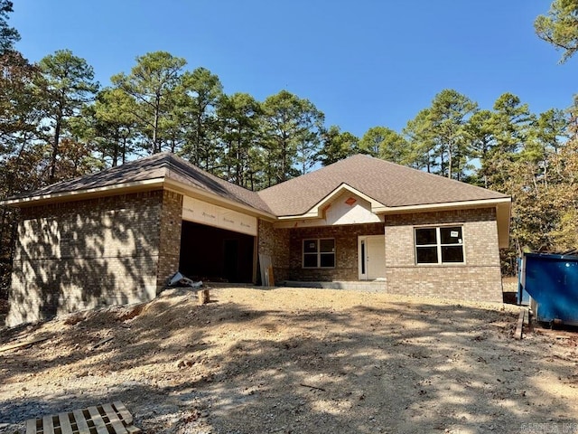 view of front of house featuring brick siding and an attached garage