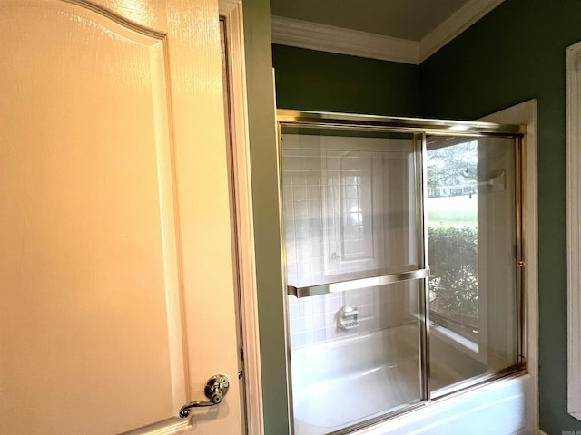 full bathroom featuring crown molding and bath / shower combo with glass door