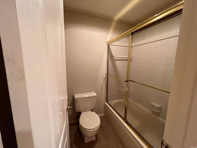 bathroom with enclosed tub / shower combo and toilet