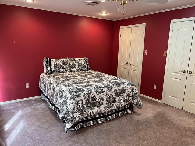 carpeted bedroom featuring ornamental molding and ceiling fan