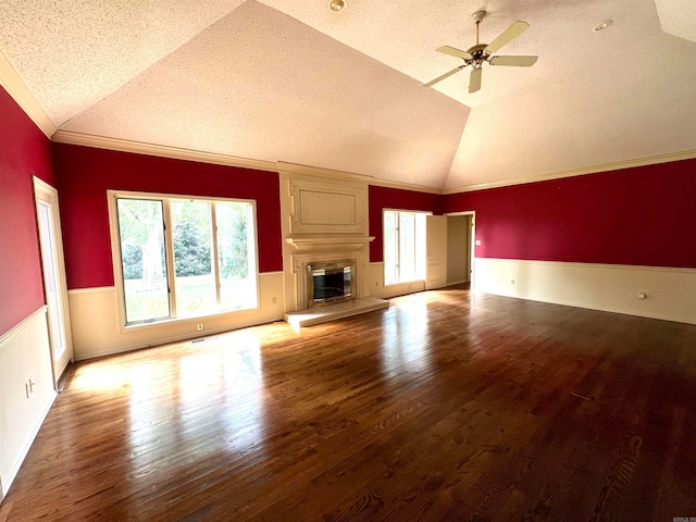 unfurnished living room with a textured ceiling, vaulted ceiling, a large fireplace, and ceiling fan