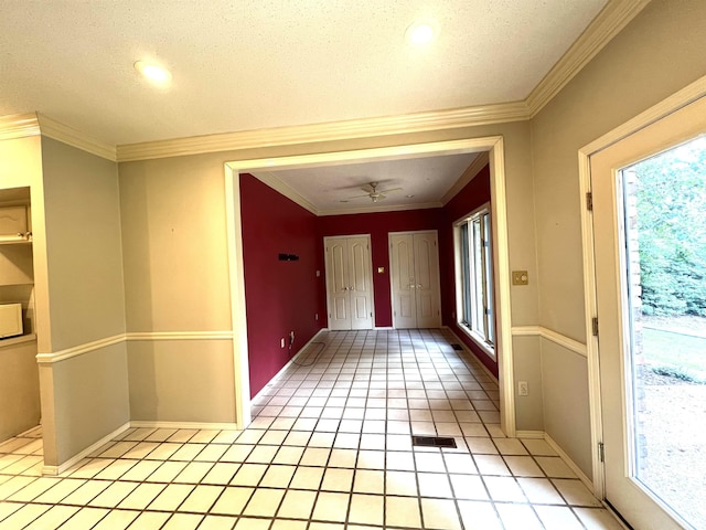 interior space featuring light tile patterned floors, baseboards, and ornamental molding